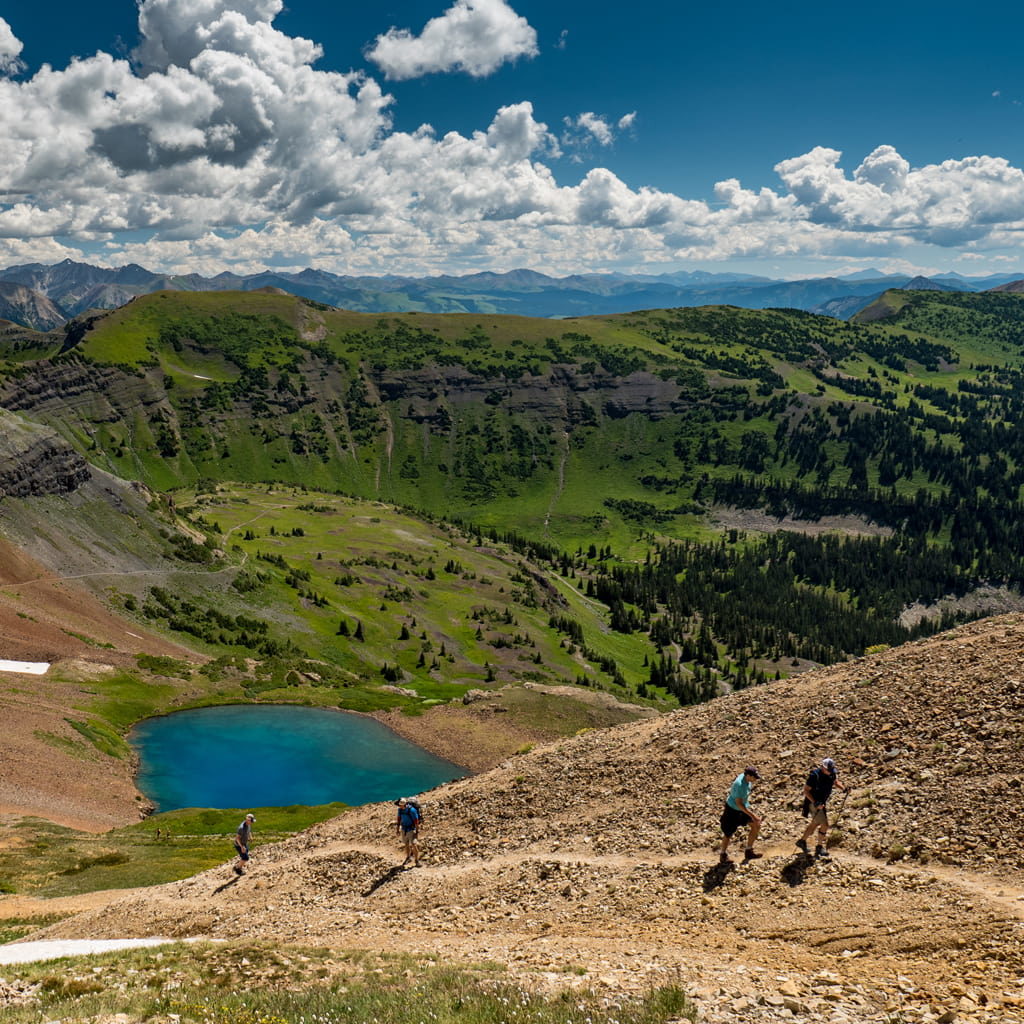 Hikers on Mt Crested Butte trails with blue skys.